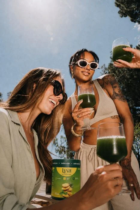Amigas brindando com suco verde